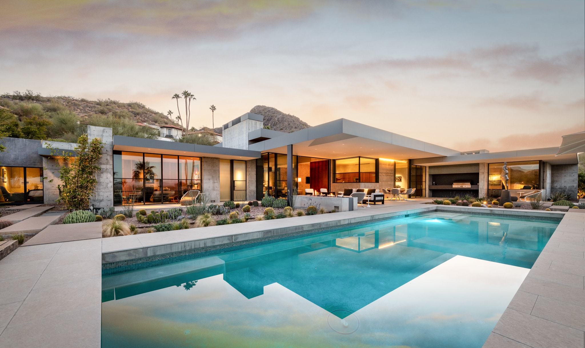 Luxury desert home with pool at dusk